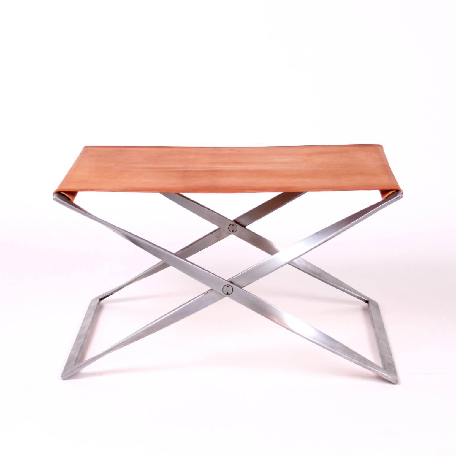 PK 91 folding stool by Poul Kjærholm.
Designed 1961.
Manufactured by E. Kold Christensen A/S, Copenhagen, Denmark.
Materials: Patinated natural leather, matte, chromed-plated steel frame.
Size: 37 x 60 x 45 cm.