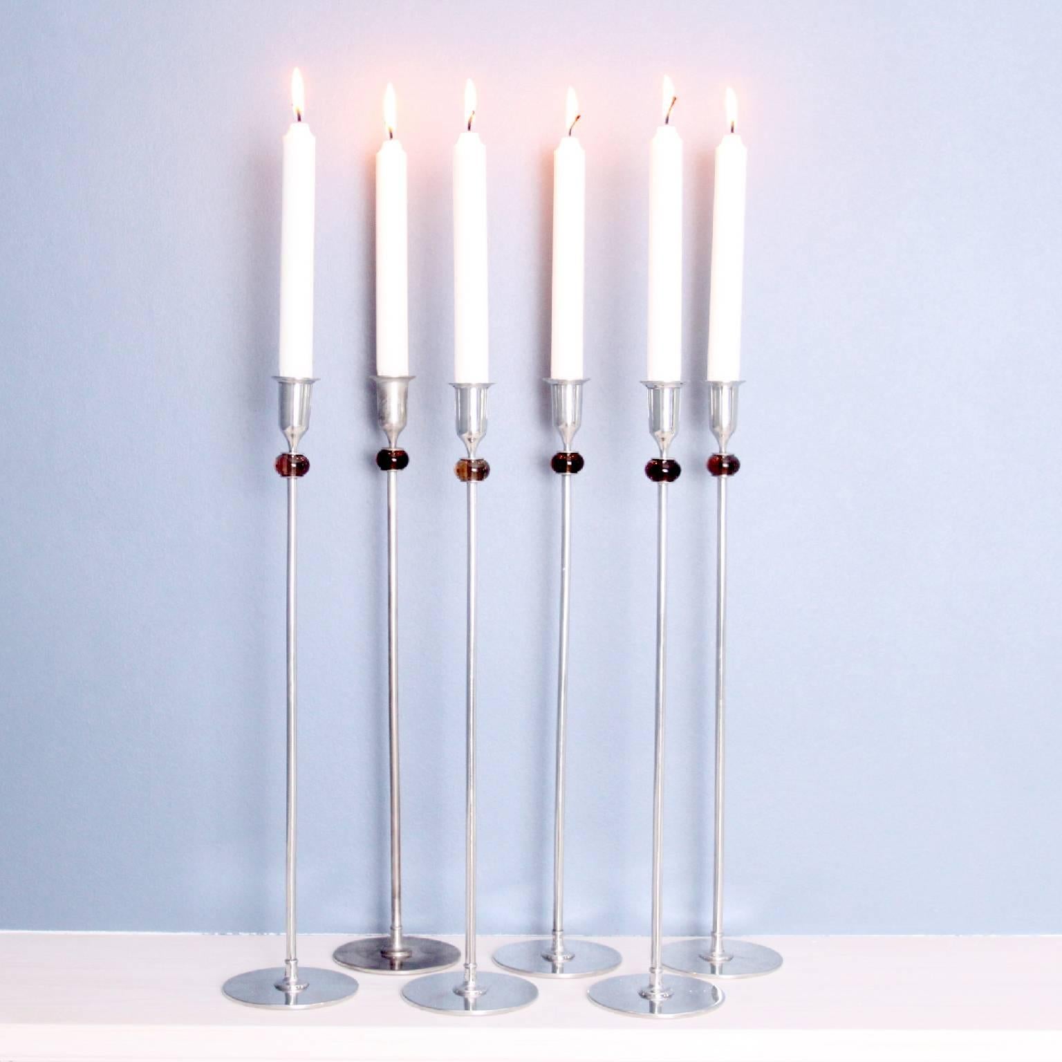Collection of six candlesticks designed by Josef Frank.
Pewter, colored glass.
Each: 44.7 cm (17 1/2 in.) high.
Manufactured by Svenskt Tenn, Sweden, circa 1956.
Underside of each impressed with manufacturer’s angel mark.
Also sold individually