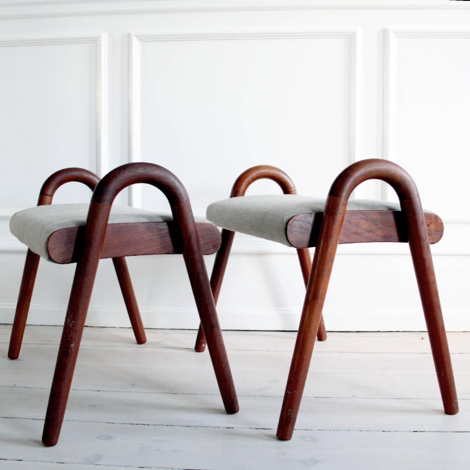 Pair of decorative stools by Vilhelm Lauritzen.

Made of teak, upholstered in grey linen. 

Designed circa 1940. 

Manufactured by Fritz Hansen, circa 1940. 

Each underside with manufacturer's mark. 

Good original vintage condition.