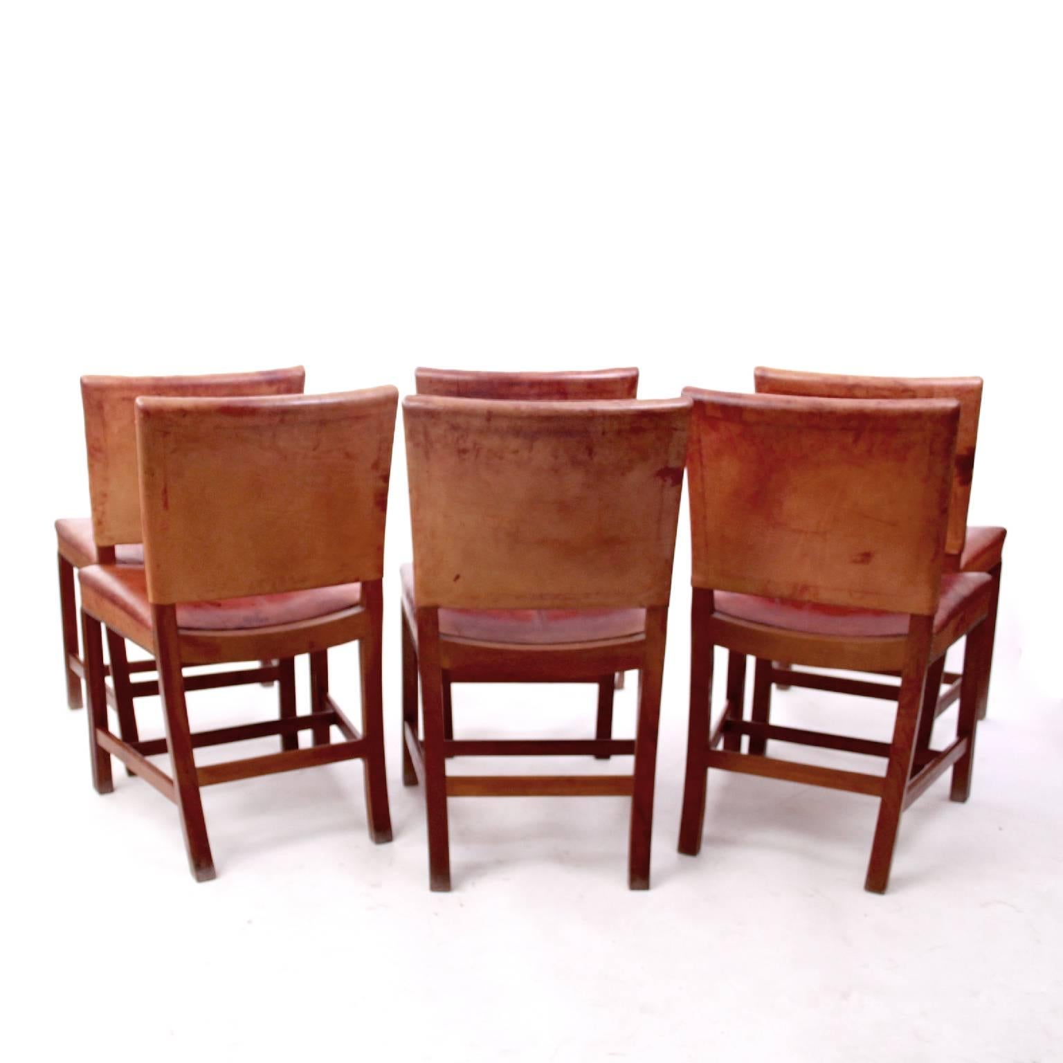 A set of six Kaare Klint 'Red Chairs'. 

Profiled legs of Cuban mahogany, seat and back upholstered with original red leather and fitted with brass nails. 

Designed 1927 for the Danish Museum of Art and Design's lecture hall. 

Executed by