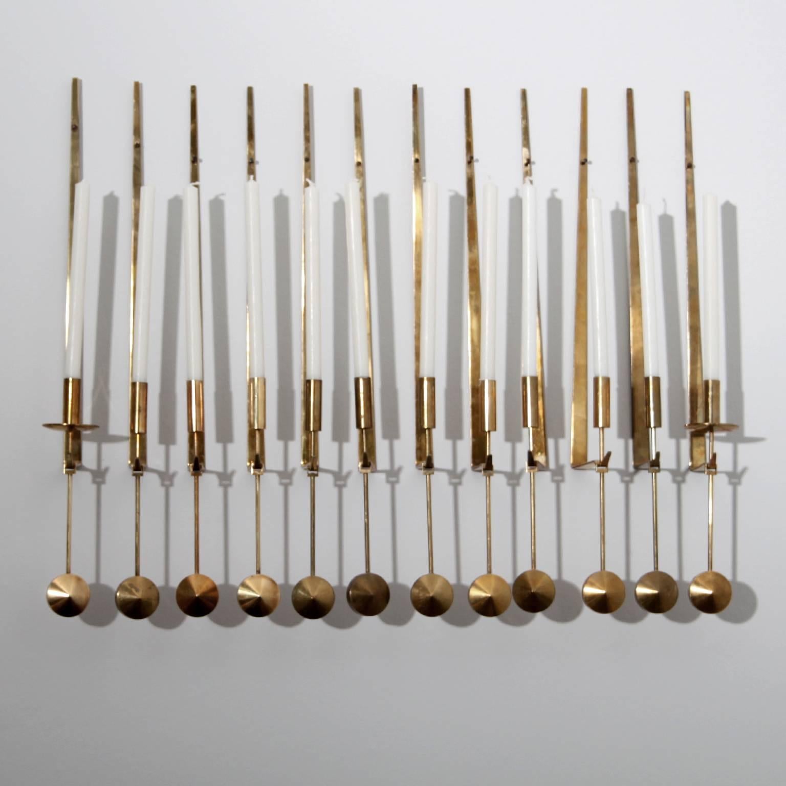 Set of 12 wall-mounted candleholders by Pierre Forsell, 1950. 

Made by Skultuna, Sweden, circa 1960. Signed with impressed manufacturer's mark to underside.

Polished brass.

Measures: H 48cm / 19