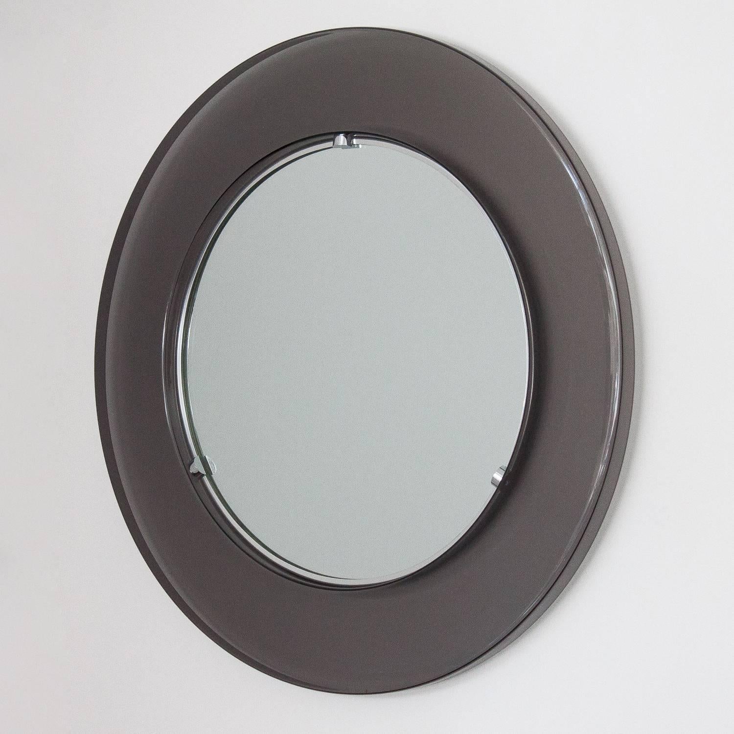 Stunning 1970s, smoke Lucite framed wall mirror. Reminiscent of glass framed mirrors by Fontana Arte. Measures: 3.75" tinted molded translucent acrylic frame with 15.5" round inset mirror. Chrome hardware. Unmarked.