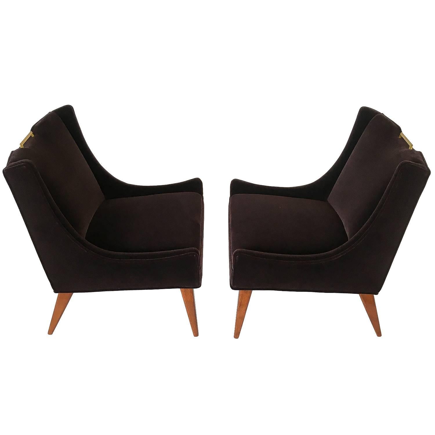 Elegant pair of Harvey Probber mohair slipper lounge chairs, circa 1960s. Newly upholstered in a sophisticated deep aubergine mohair. Brass handle detail located at the top of the back. Original finish to the walnut legs. The walnut legs do show so