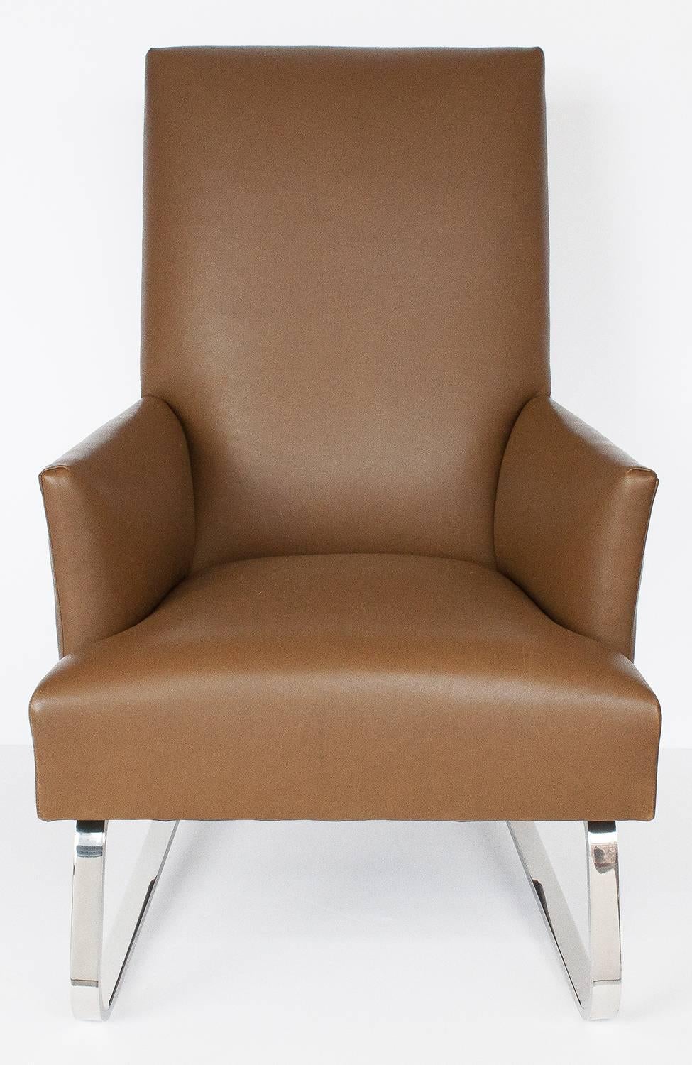 Leather Odeon club lounge chair by Donghia. Fully upholstered chair with tight seat and back. The upholstered frame is raised on a formed and polished chromed steel cantilever base. Upholstered in a light caramel brown leather. Leather shows signs