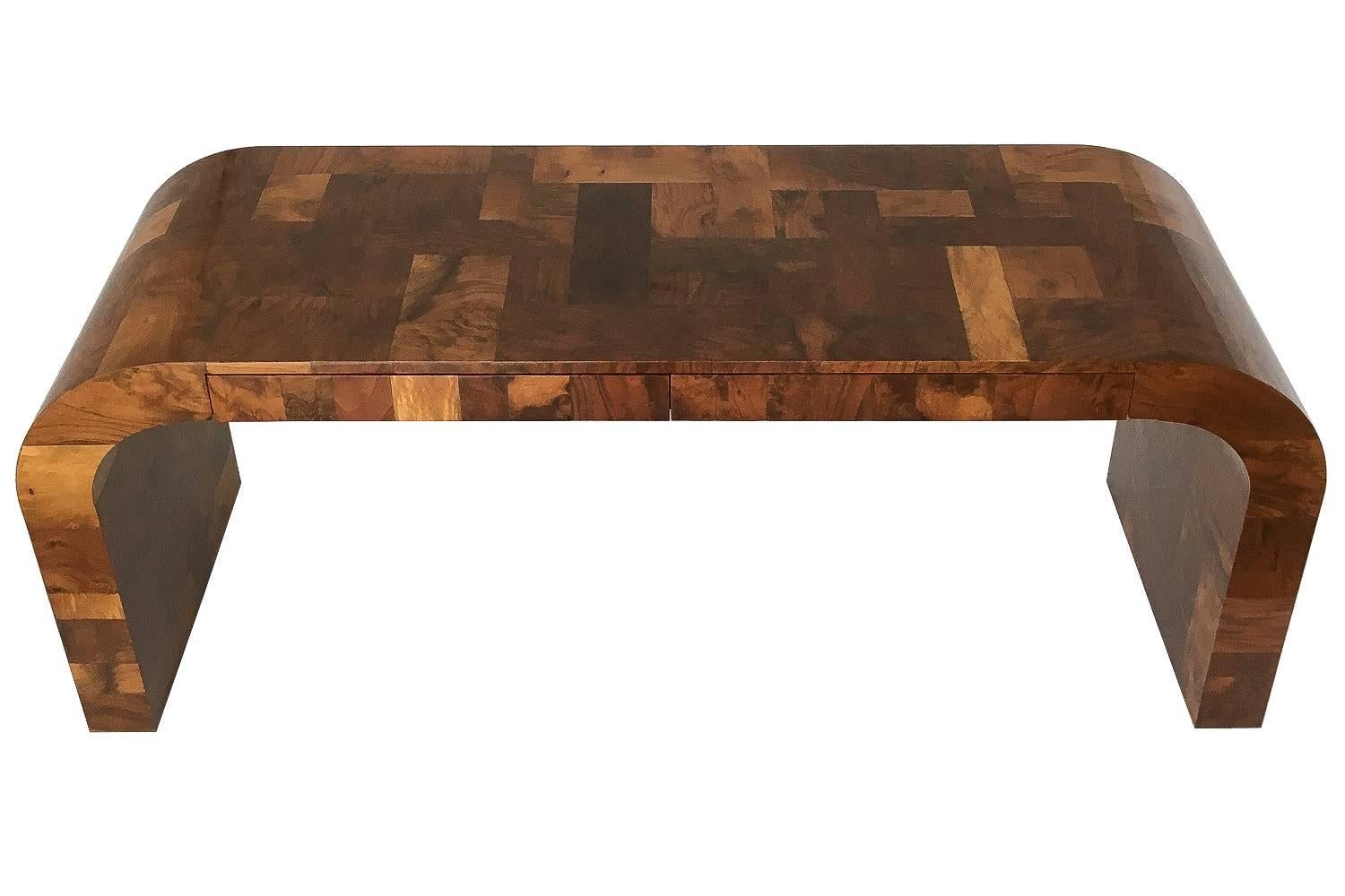 Paul Evans patchwork cityscape console table or writing desk in a rich walnut toned burl wood for Directional Furniture, circa 1970s. Waterfall design with two drawers that can be used as either a console table or desk. Original high gloss lacquered