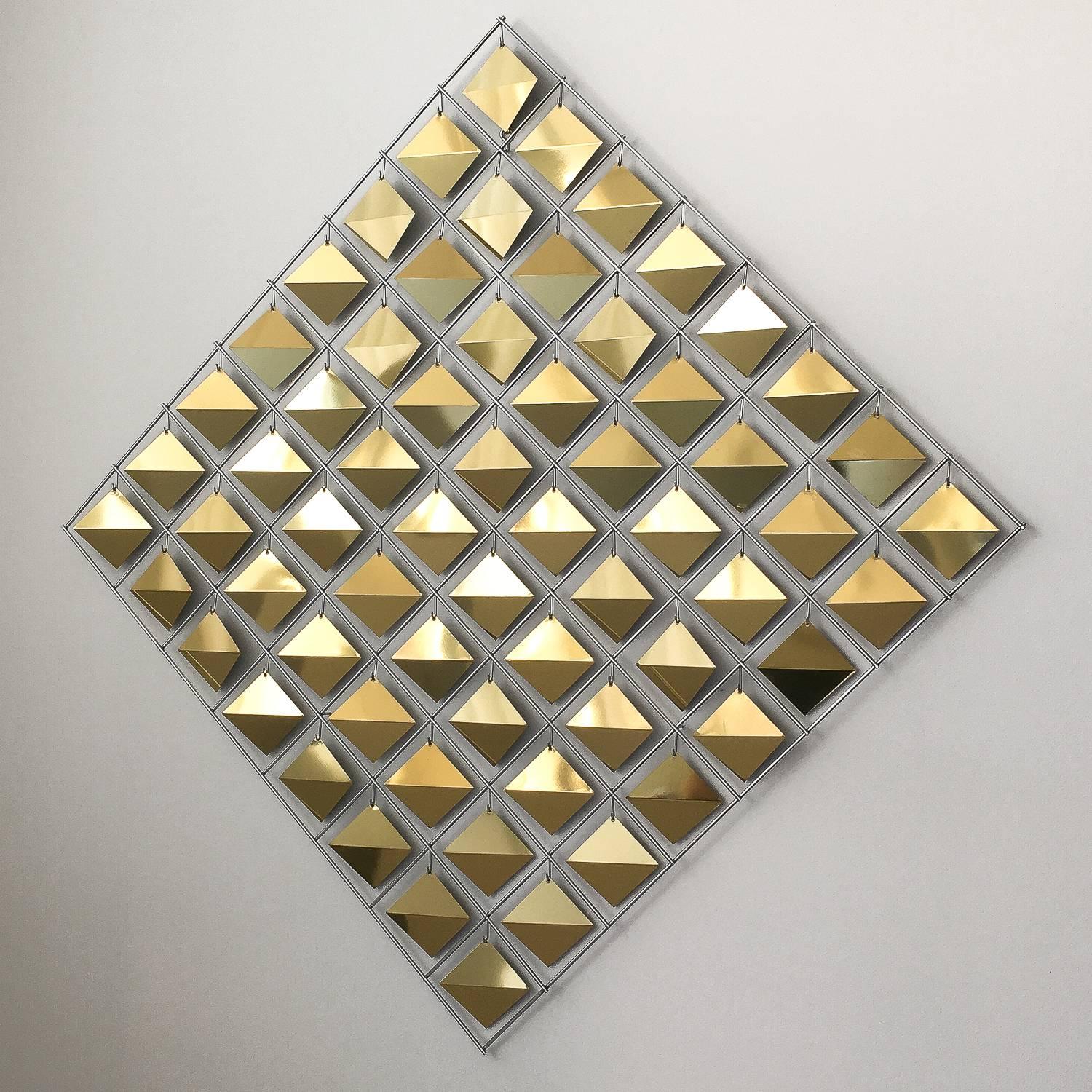 Curtis Jere brass diamond shaped wall sculpture. 64 faceted brass diamonds are suspended from a chrome framework. The 3