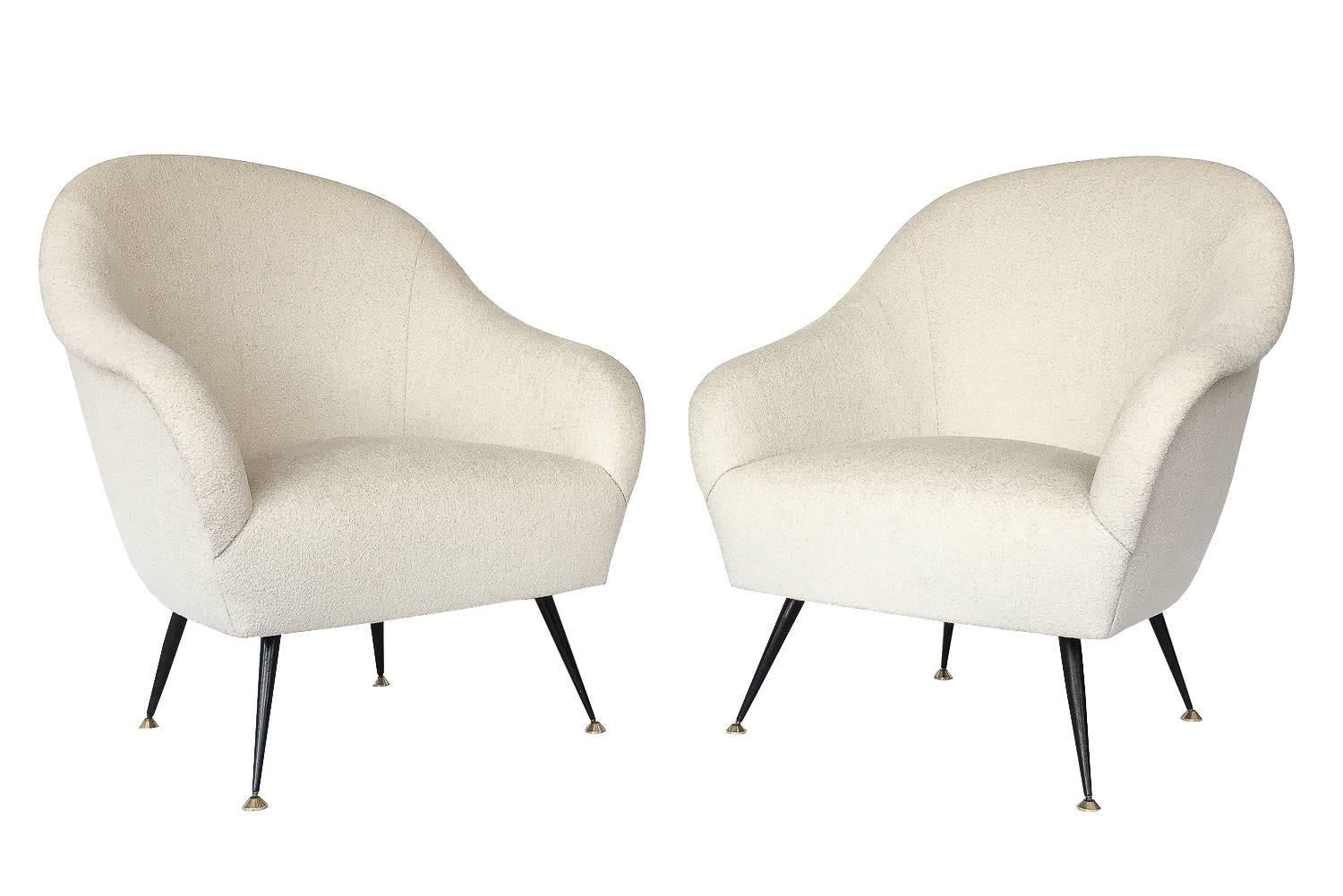 Pair of Antonio Gorgone Italian lounge chairs with metal stiletto legs. Newly upholstered in a bone colored chenille fabric. Curvaceous design with tight upholstered seat and back. Slight reveal of curved armrest. Black painted angled metal legs