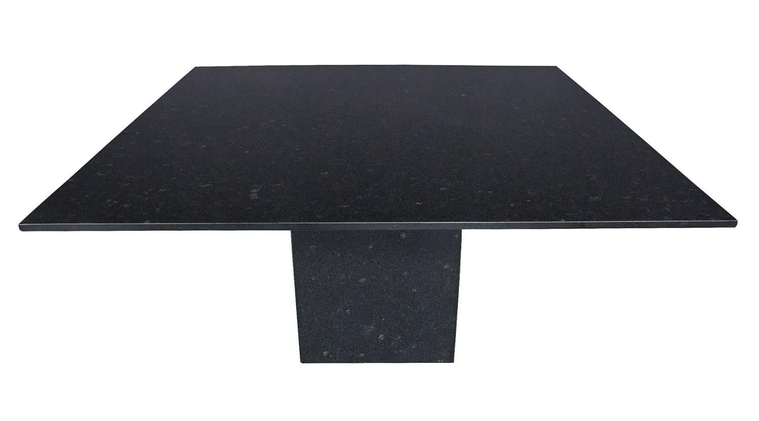 Monolithic solid black granite pedestal dining table. 3/4