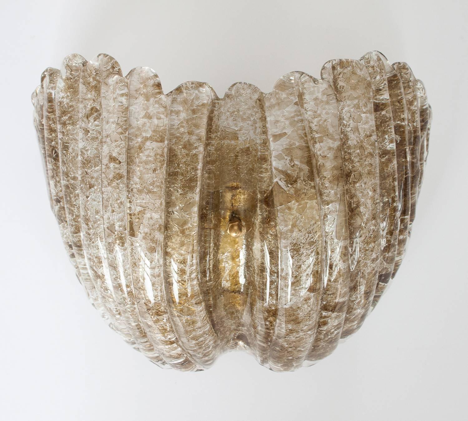 Pair of Kalmar shell form glass wall sconces in a smokey topaz color. Unique crackled ice glass. Brass hardware. Takes two E-14 base light bulbs. 4.25