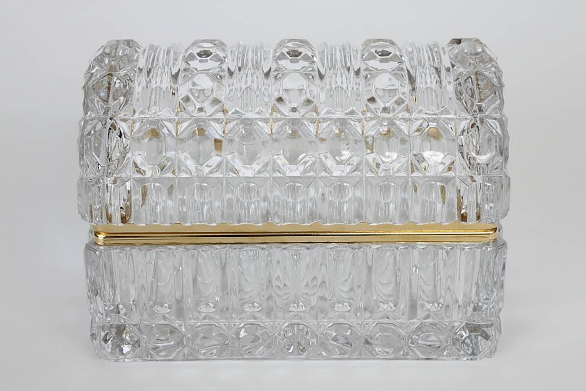 A large antique cut glass box with quilted cut pattern on all sides. 20 point star burst design on bottom.  Curved domed top.  Piano style brass hinged lid.  Unmarked.  Heavy thick glass. 