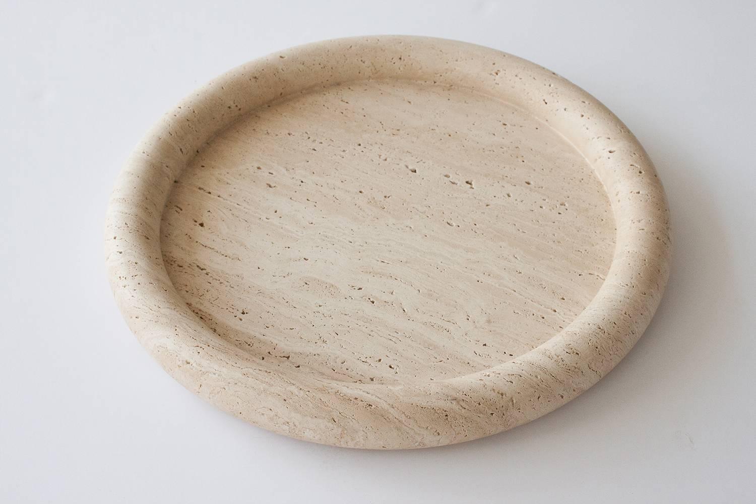 Rare solid travertine centerpiece charger by Egidio Di Rosa and Pier Alessandro Giusti for Up&Up. Excellent condition with natural inclusions within the stone. Unmarked.