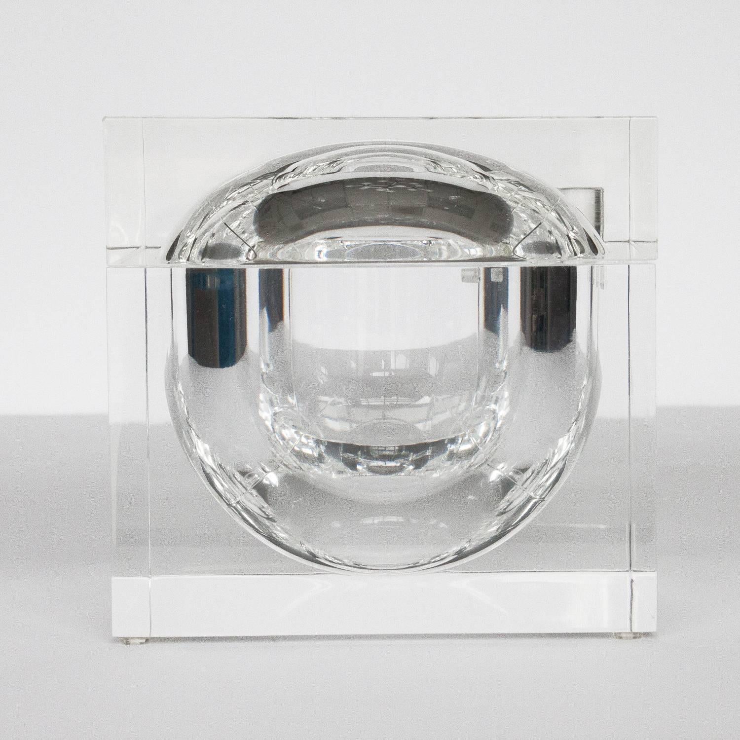 Sculptural thick cube form Lucite ice bucket with sphere shaped void and swivel top lid. Inner cavity measures 6.5