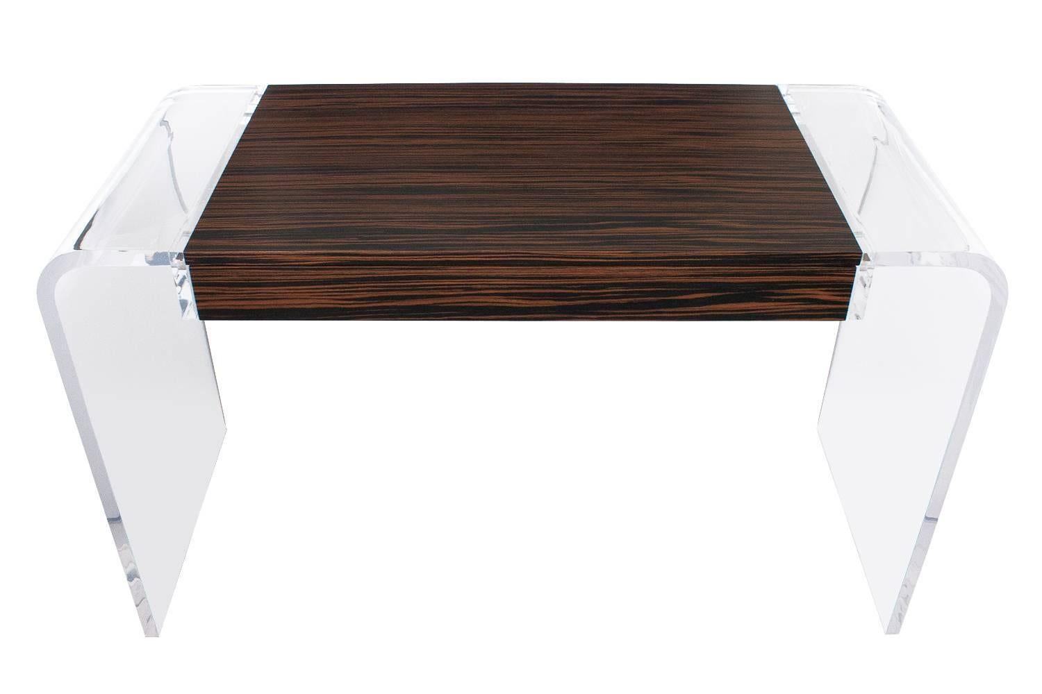 Stunning macassar ebony and lucite floating desk. The piece has a wide variety of uses such as a desk, vanity, writing table or console table.  

A macassar case and drawer are suspended between two one inch thick bent lucite legs. The case