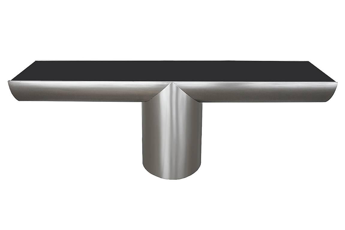 Brueton Tee console table by J Wade Beam. Deliberate sculptural interplay of cylindrical forms characterizes the Tee Console. The simplicity of the pedestal base flows into the cantilevered arms which are sliced to express and reveal the depth of