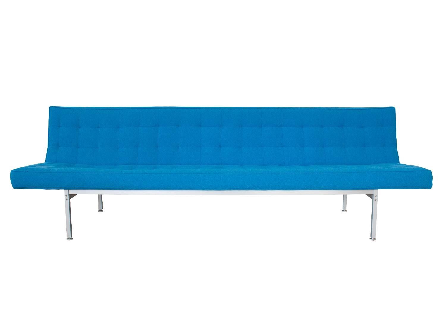Minimal 8 foot armless sofa with exposed aluminum legs / framework. Reminiscent of Florence Knoll, Jens Risom and George Nelson. Unmarked. Upholstered in original bright marine blue woven fabric. Tufted tight seat and back. Solid aluminum frame.