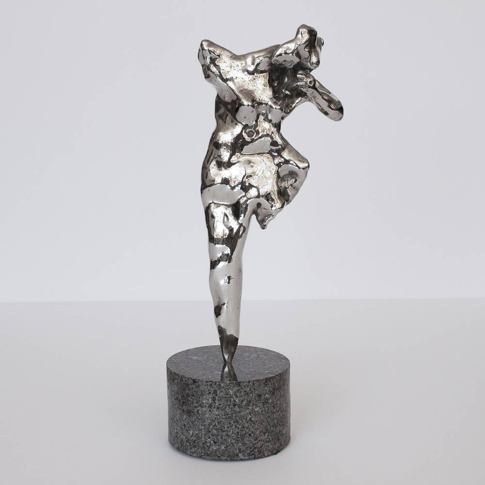 This sculpture features a polished nickel-plated cast bronze abstract female nude. Mounted on solid gray granite. The granite is honed on the sides and polished on the top. Base measures: 2.75