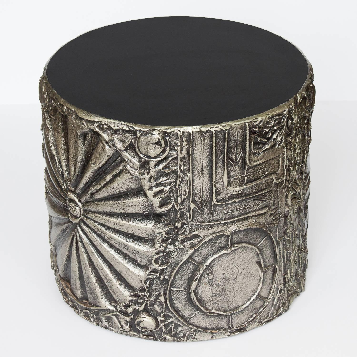 Paying homage to 'Paul Evans' sculpted bronze series, this Brutalist drum table by Adrian Pearsall features black laminate top and abstract motifs in a sculpted resin. The table is decorated in a high relief sculptural warm silver and black resin.