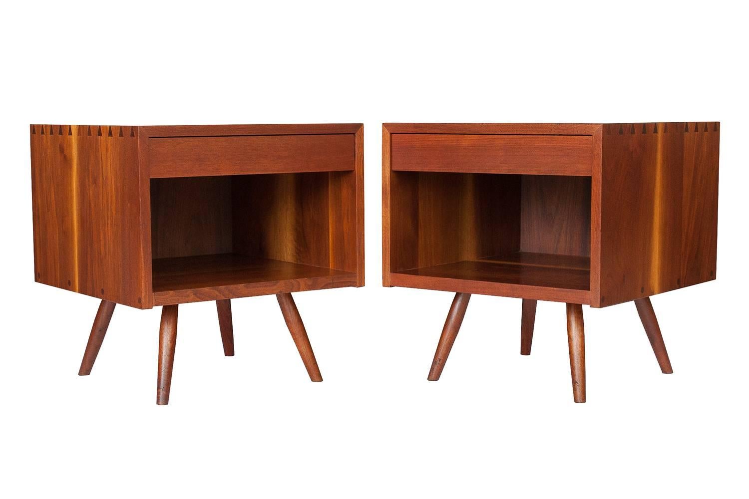 Pair of rare Nakashima Studio nightstands or end tables in American black walnut. Solid walnut construction. Hand-cut dovetail joints and a single drawer. Hand rubbed oil finish. 

Nakashima's 1962 catalogue gives a detailed description of the