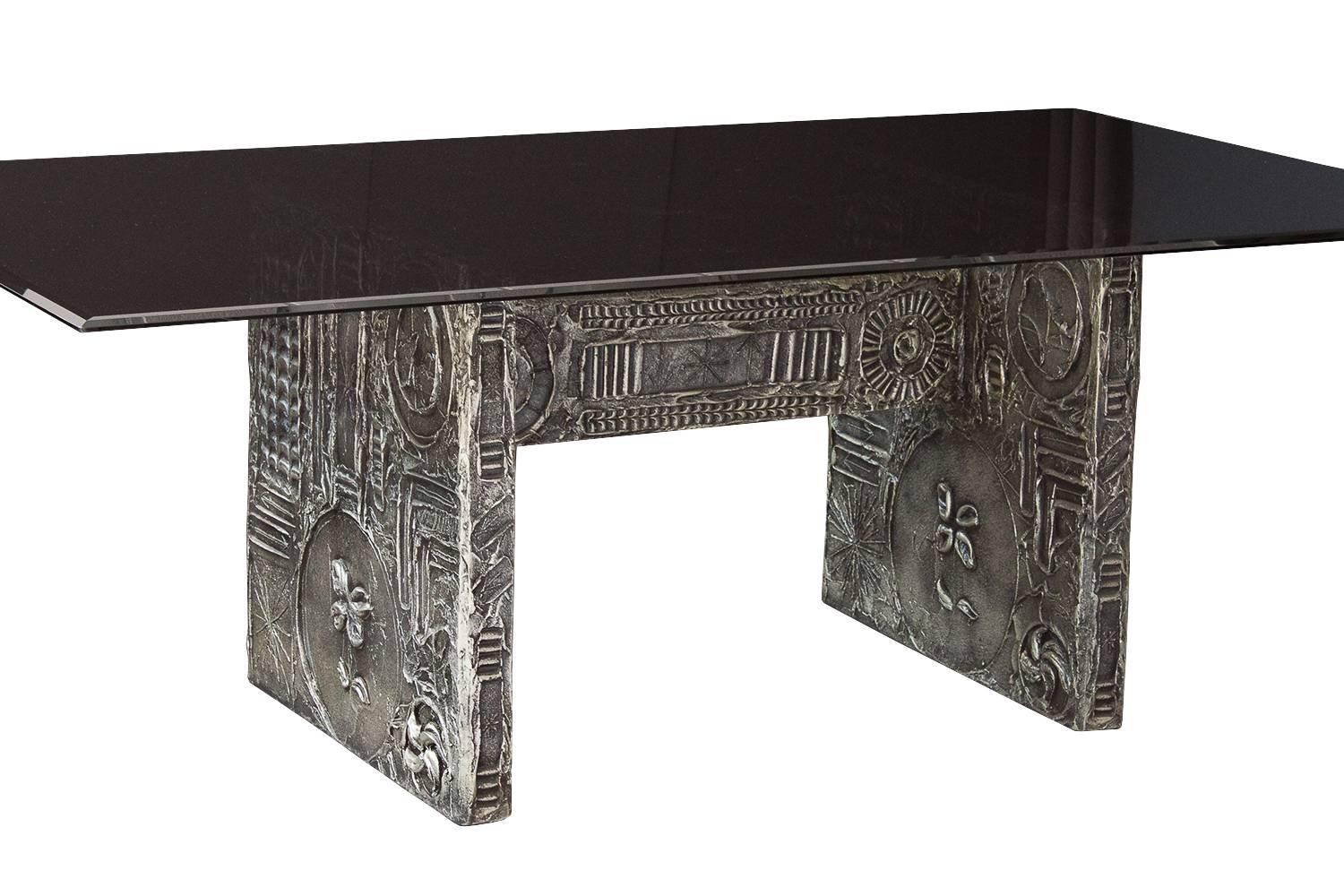 Paying homage to 'Paul Evans' sculpted bronze series, this Brutalist dining table/ desk by Adrian Pearsall features abstract motifs in a sculpted resin. The trestle base is decorated in a high relief sculptural warm silver and black resin. Double