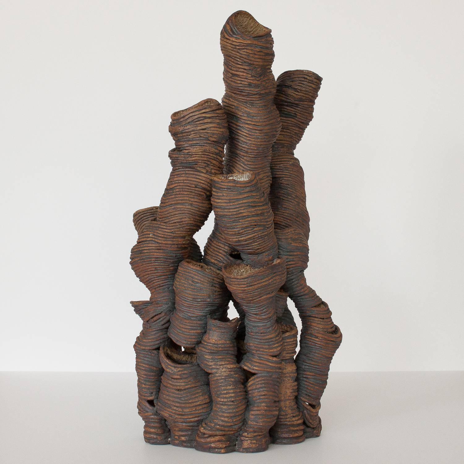 Monumental 28" tall studio pottery coil sculpture. Abstract organic form. Brown and black glaze on exterior with white and natural glaze on textured interior. Unmarked.