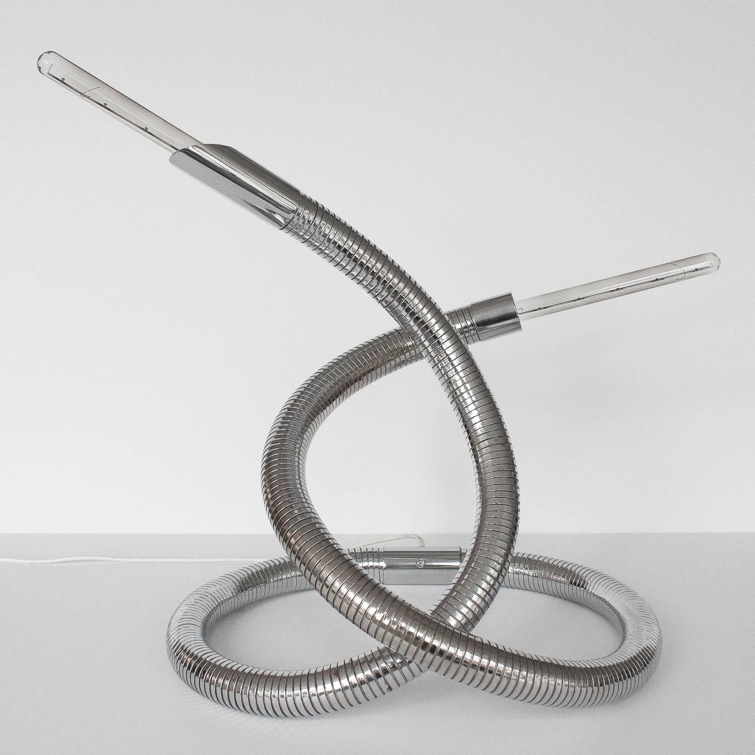 Rare and unusual 1960s Italian chrome flexible snake lamp. A 10 foot long chrome plated bendable 2" diameter metal tube can be configured in an infinite number of positions. Each end features a different shape fitting to create the sense of a