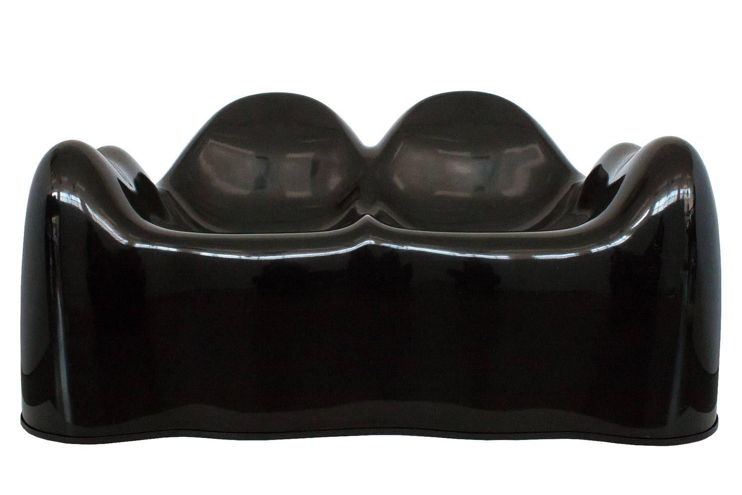 Rare and uncommon black Molar Settee by Wendell Castle, circa 1969 and distributed by Beylerian. The settee or loveseat is comprised of gel-coated fiberglass reinforced plastic. A stunning and sculptural iconic piece of design. This settee was part