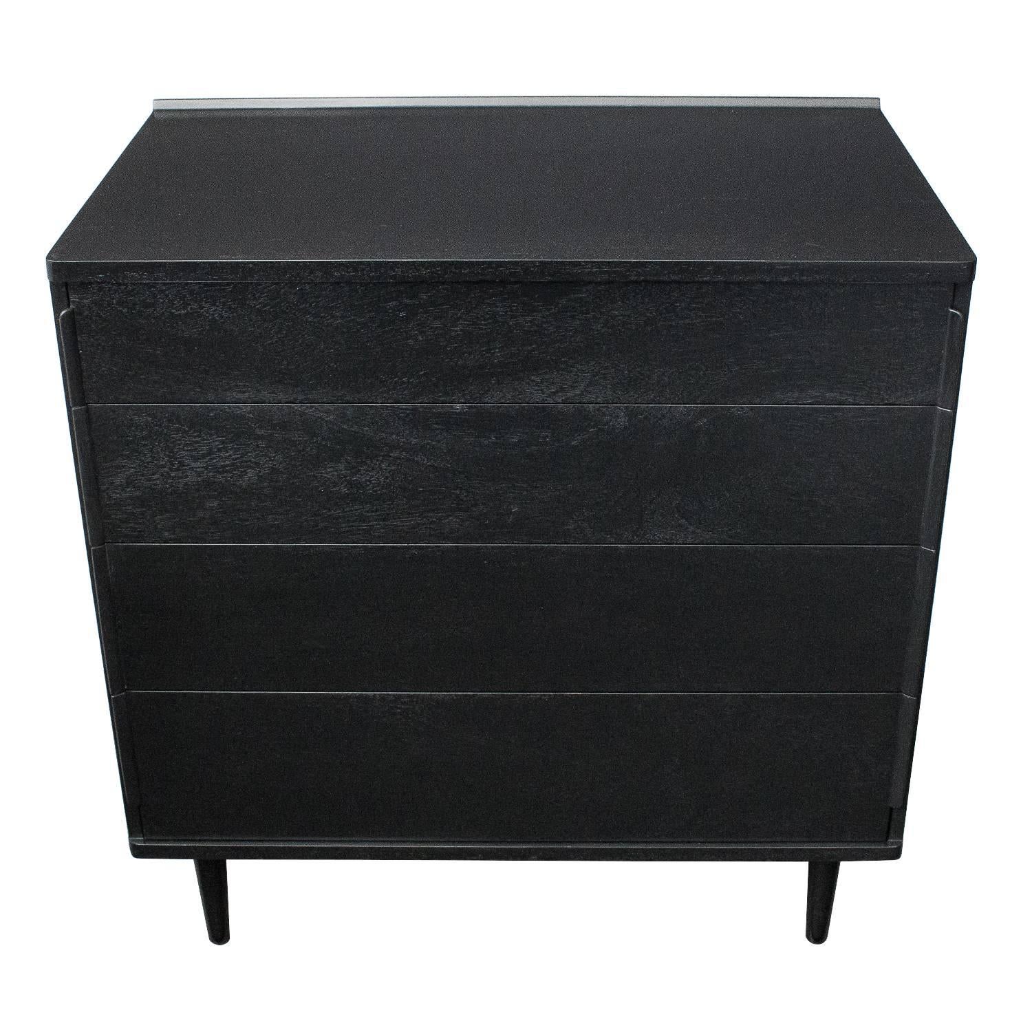 Four-drawer ebonized mahogany chest by Edward Wormley for Dunbar, circa 1950s. Model 5269A. Four drawers with vertical laminated end pulls running the length of the cabinet. Tapered dowel legs. Finished on the back side. Beautiful black ebonized