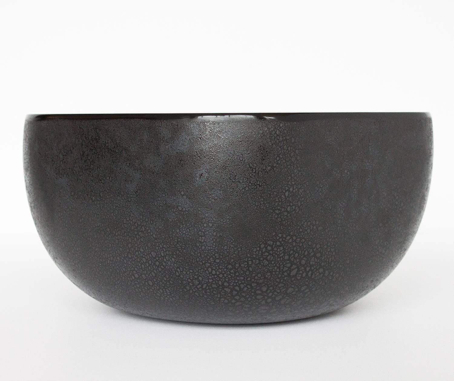 Barbini Murano large black art glass bowl with textured and frosted scavo or corroso technique. Engraved signature to bottom of bowl and numbered 310. Very tiny flea-bite chip on flat edge of glass rim. See photos.

 

 