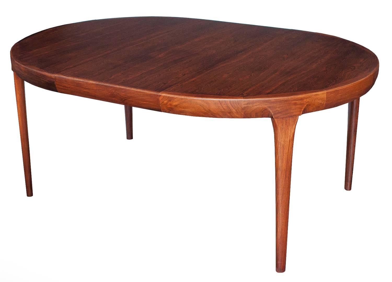 Rosewood dining table by Ib Kofod-Larsen with two 19.75