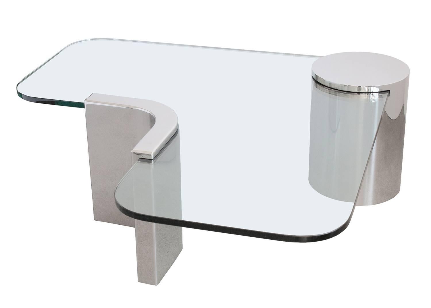 Unique and sculptural cantilevered coffee table in the style of J Wade Beam for Brueton / Pace Collection. A 3/4" thick L-shaped glass is suspended within two polished steel supports. A 12" diameter steel cylinder and a 2.5" thick