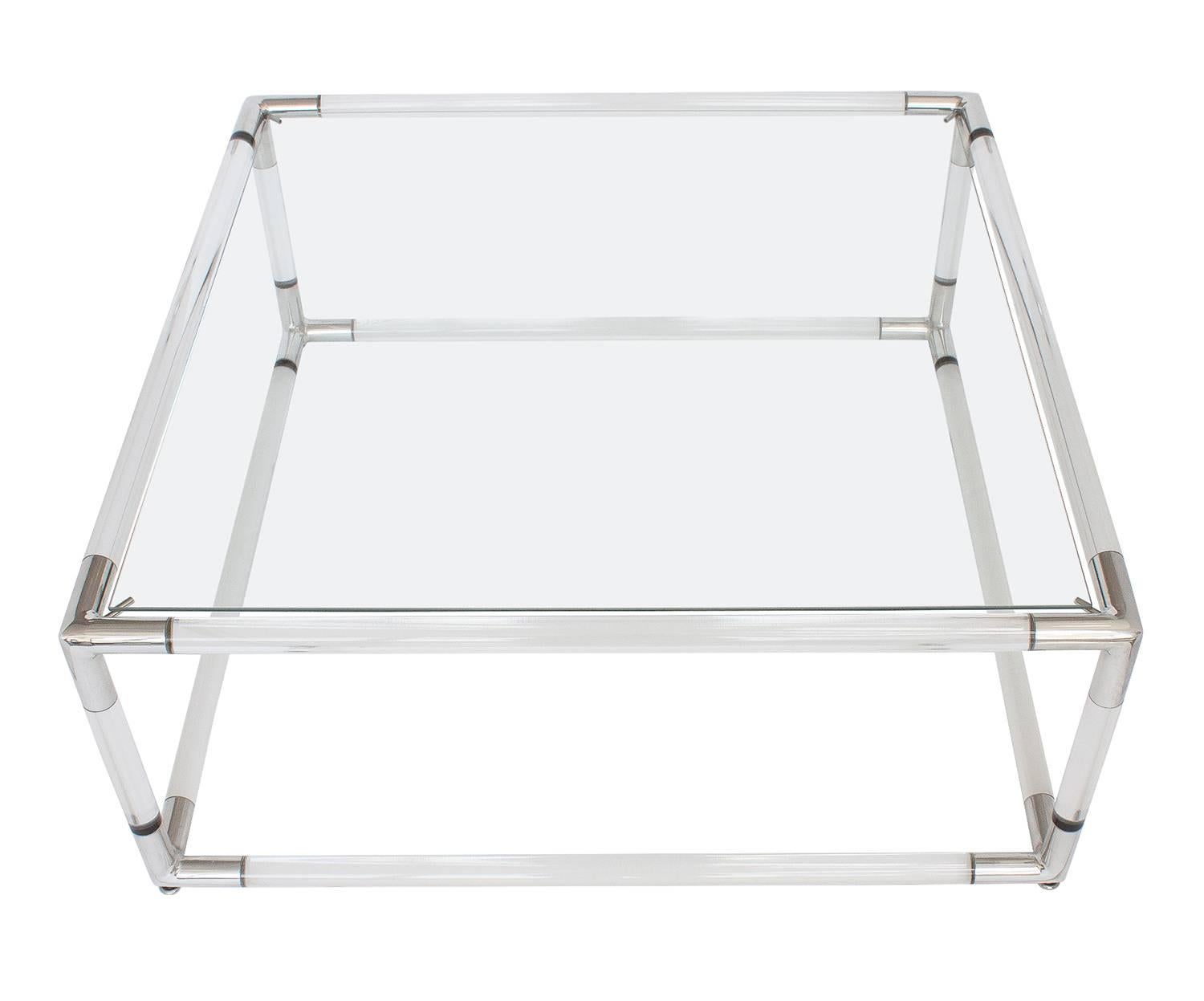 Lucite coffee table with polished aluminium corners and recessed glass top. Measures: The Lucite bars are 1.25