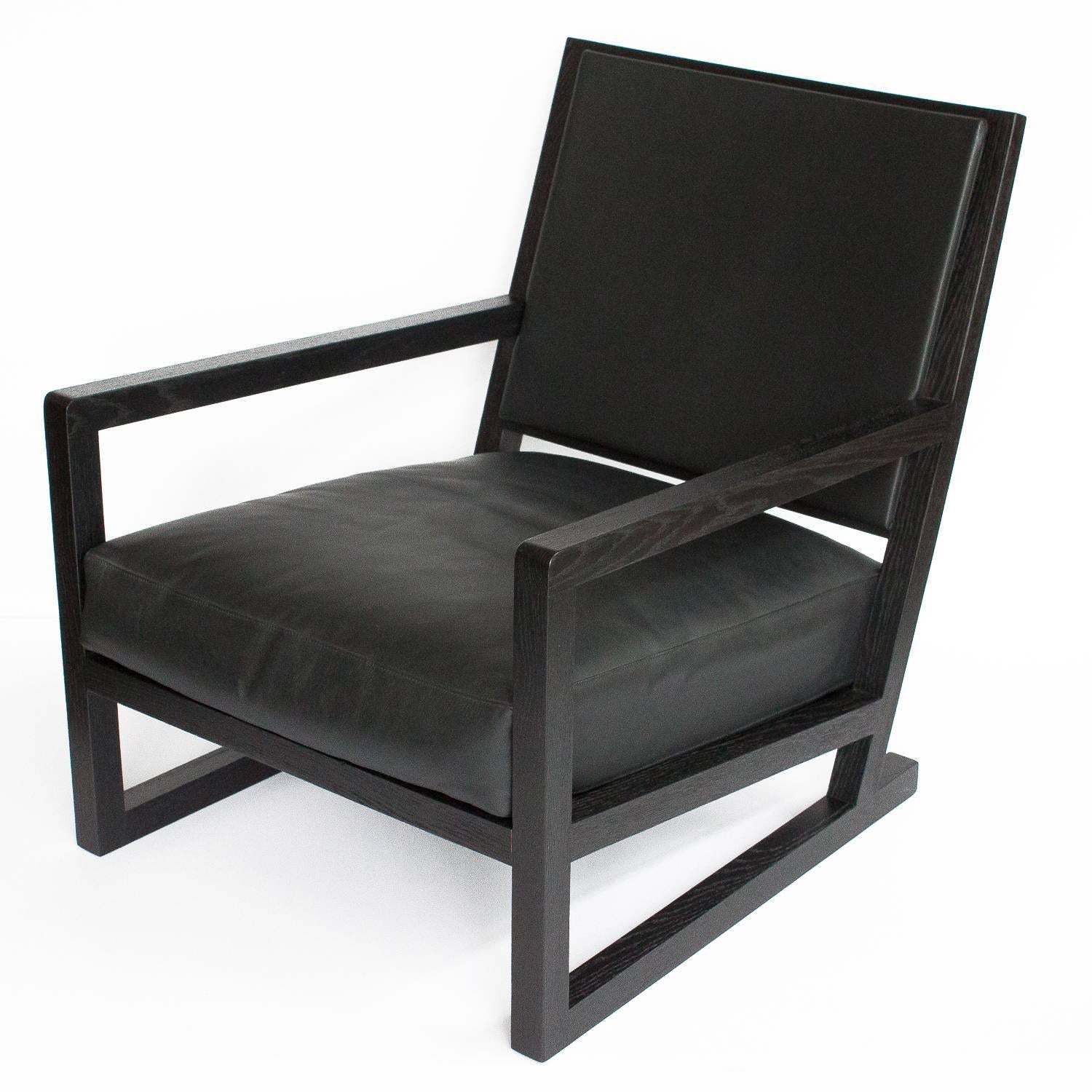 Clio armchair by Antonio Citterio for B&B Italia / Maxalto. From the Simplice collection, 2005 production year. Solid oak frame with a brushed black ebonized finish. The seat and back are upholstered in a charcoal leather. The loose back pillow