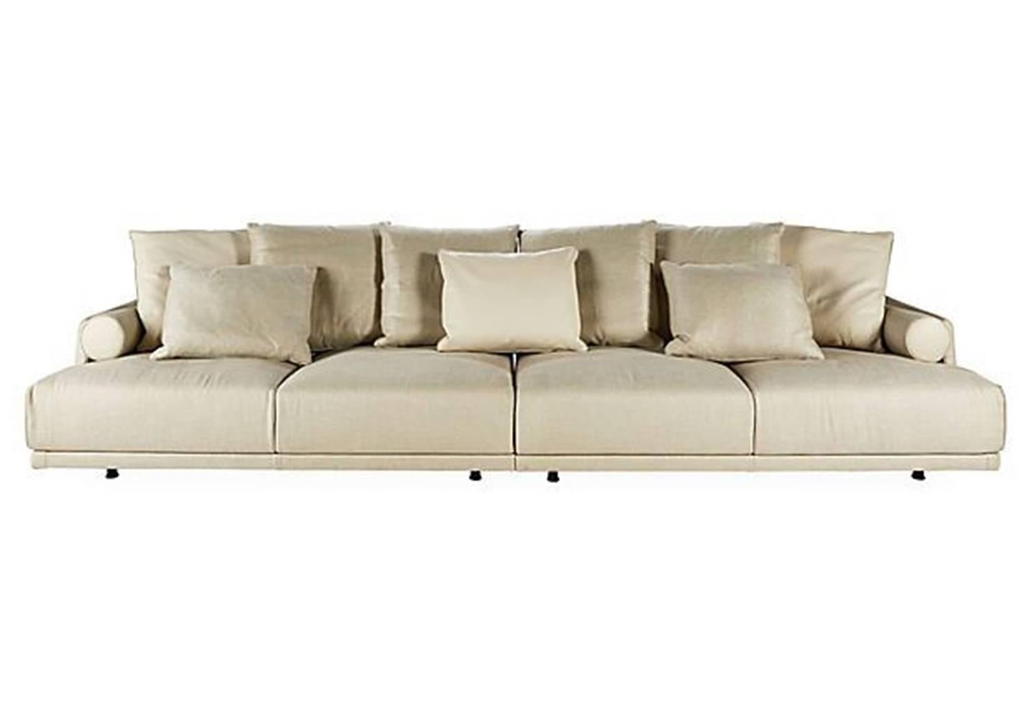 Sofa in beige fabric with piping in beige leather.
Pillows half in beige leather, half in beige fabric
