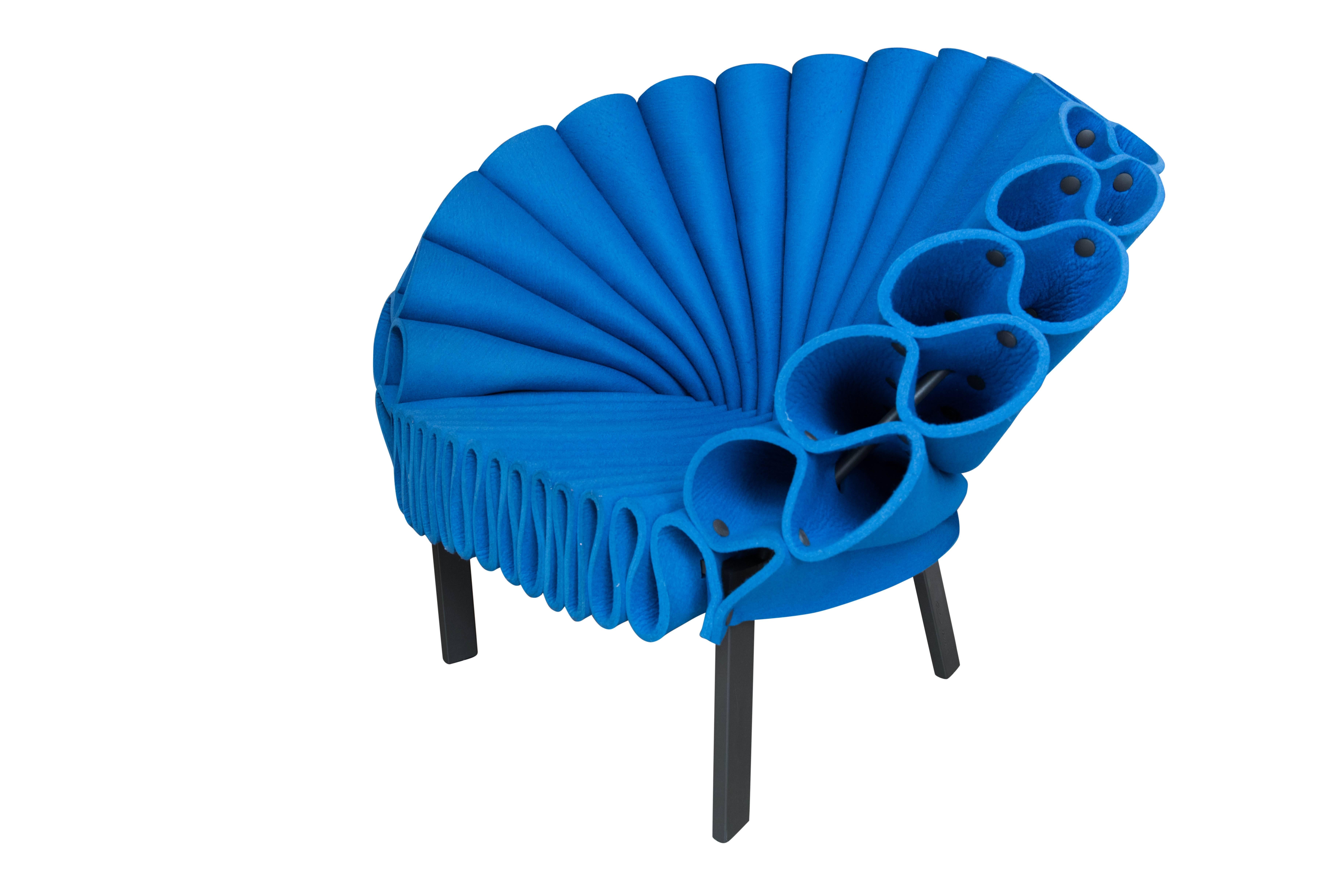 This brand new peacock chair, by famed Italian furniture house Cappellini is a truly unique addition to any home or office.

Description:
Armchair constructed of crumpled sheets of felt, mono-color (blue). Base in metal, powder varnished in dark