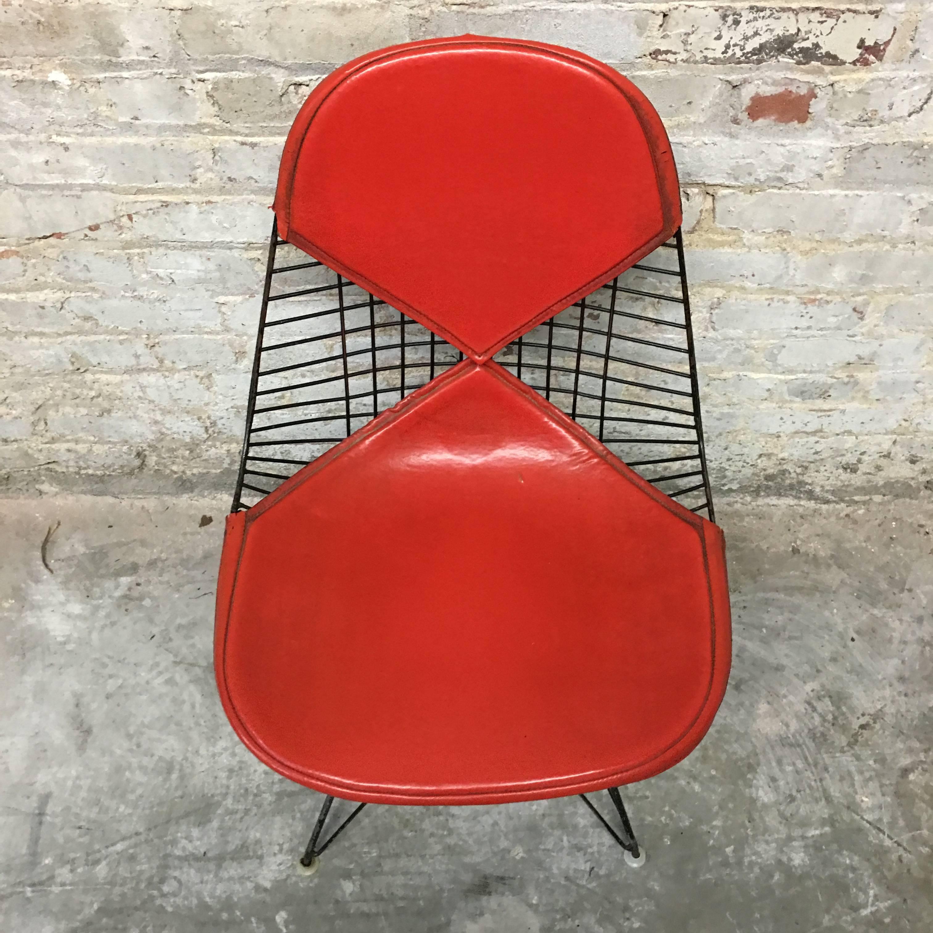 Herman Miller Eames DKR-2 Bikini chair on Eiffel base. All glides intact. Naugahyde pads in very good vintage condition with normal wear commensurate with age and use. Excellent bright red pads with no fading. Base welded to shell so this cannot be
