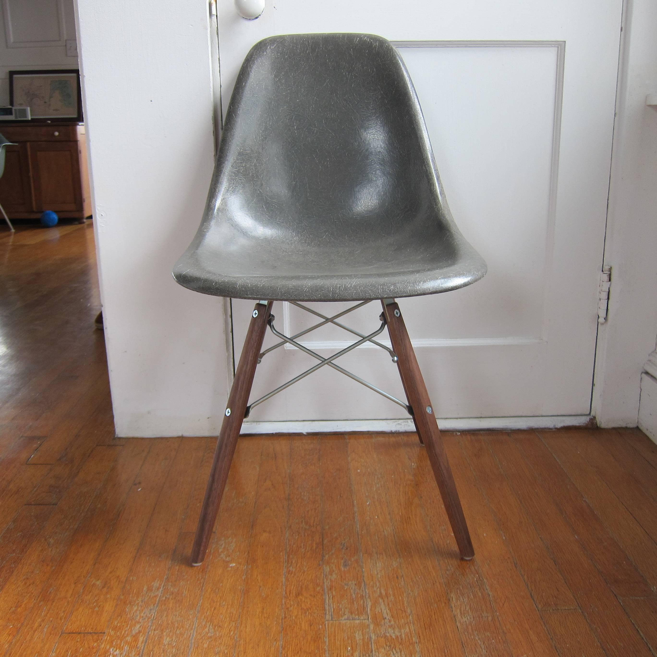 Eight Herman Miller Eames dining chairs in assortment of colors. The bases are new and made in the USA by Modern conscience. Walnut legs, also available in maple. Fiberglass shells free of cracks, holes, or significant wear. Shells have normal wear