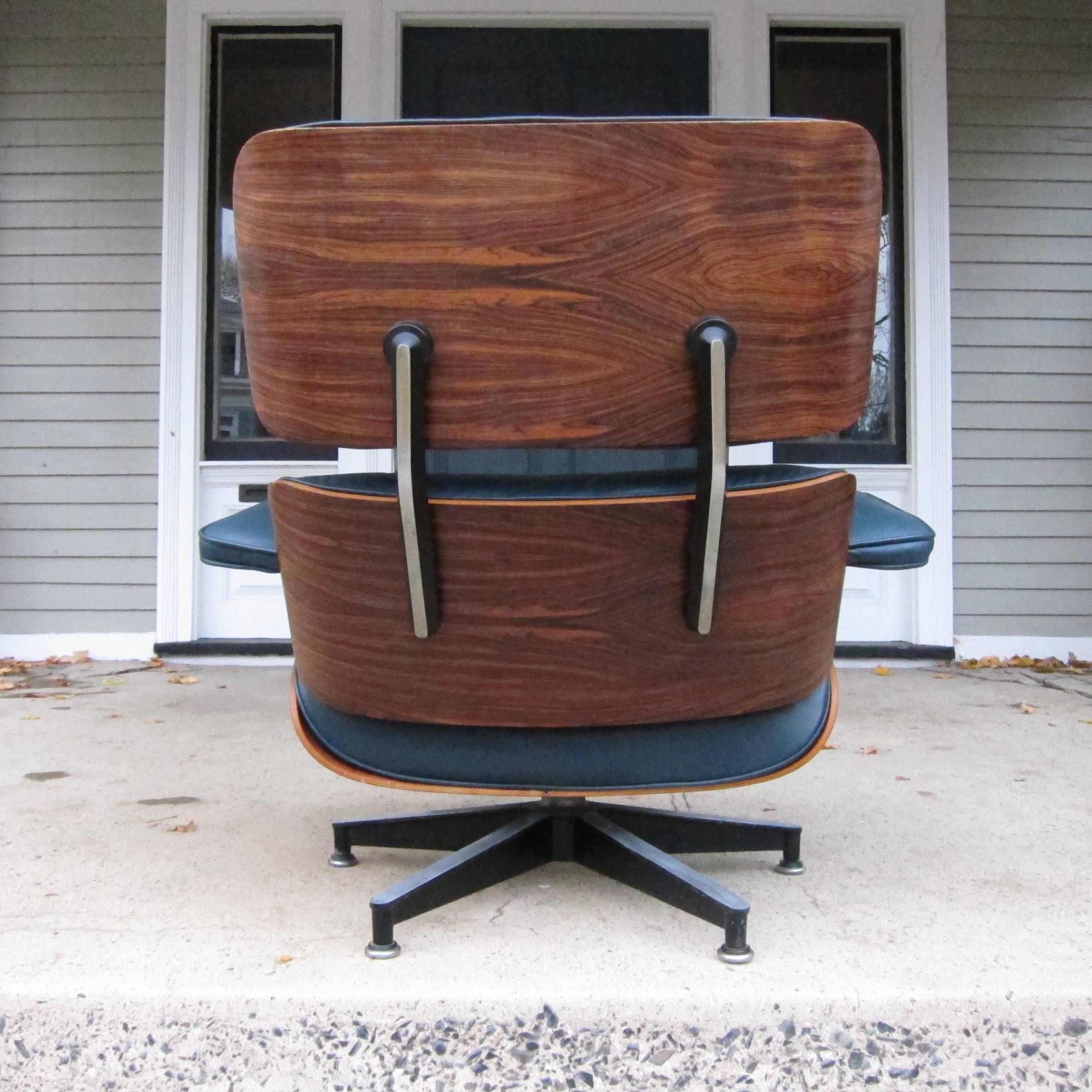 Eames lounge chair in Brazilian rosewood and custom indigo leather. As nice as a vintage lounge gets in near perfect condition. Originally purchase with other chair and ottoman, the only time we have come across this color. Signed 1976 on Herman