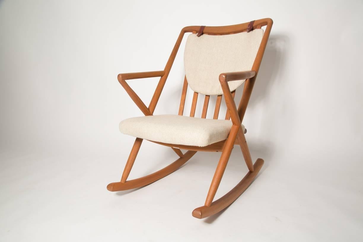 Honey teak and cream rocking chair by renowned Danish designer Benny A Linden with removable back cushion. The upholstery is cream and camel wool. This rocking chair was produced by Benny A Linden using Classic build methods and excellent material.