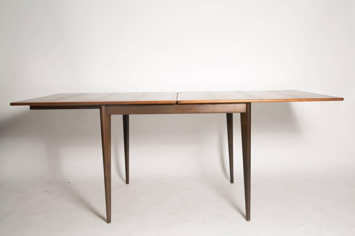 Beautiful Nils Jonsson rosewood flip-top extendable table with brass hinges. Beautifully figured rosewood grain and legs set at a 45° angle. Made in Sweden in 1960 (see maker's mark photo). Excellent vintage condition with normal