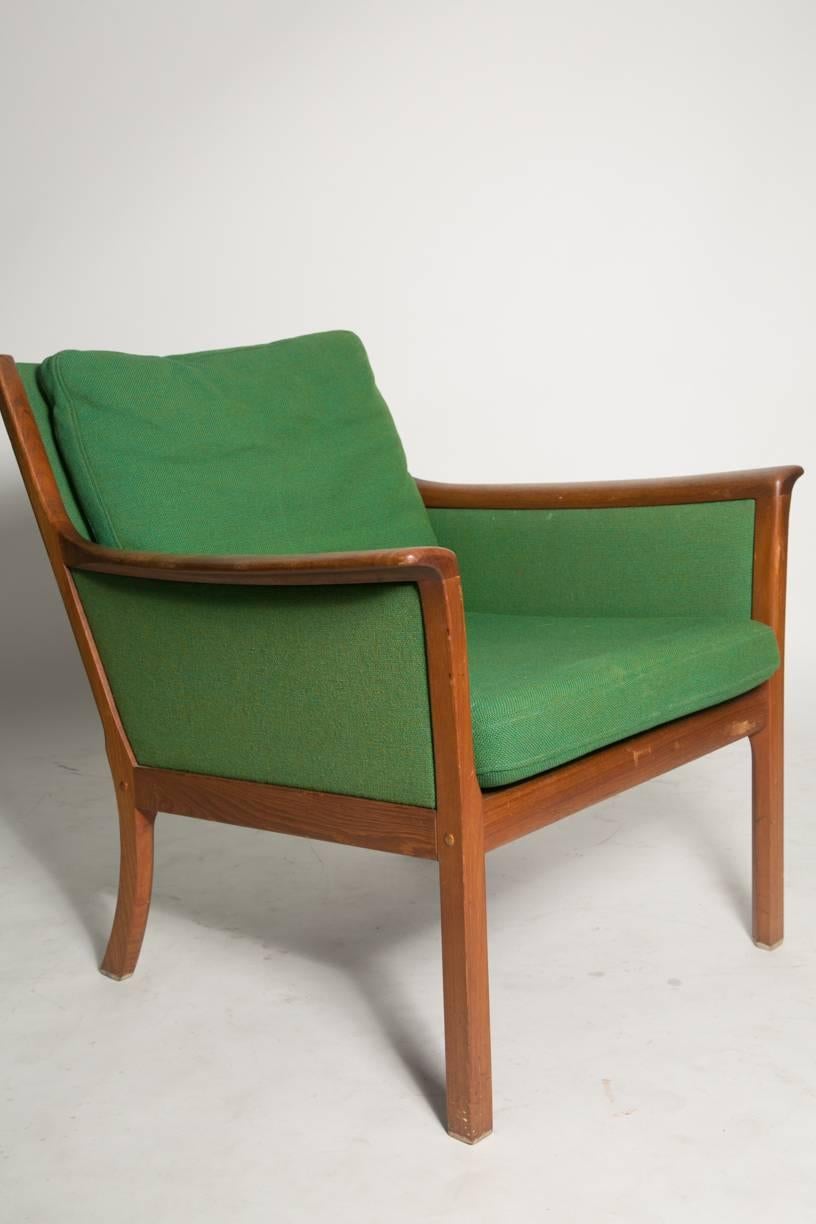 Ole Wanscher Japan lounge chair. Sculptural teak armchair with navy green and emerald green two tone fabric designed by Ole Wanscher for Poul Jeppesen during the 1960s. The design is an interesting combination of elegance and fun.
