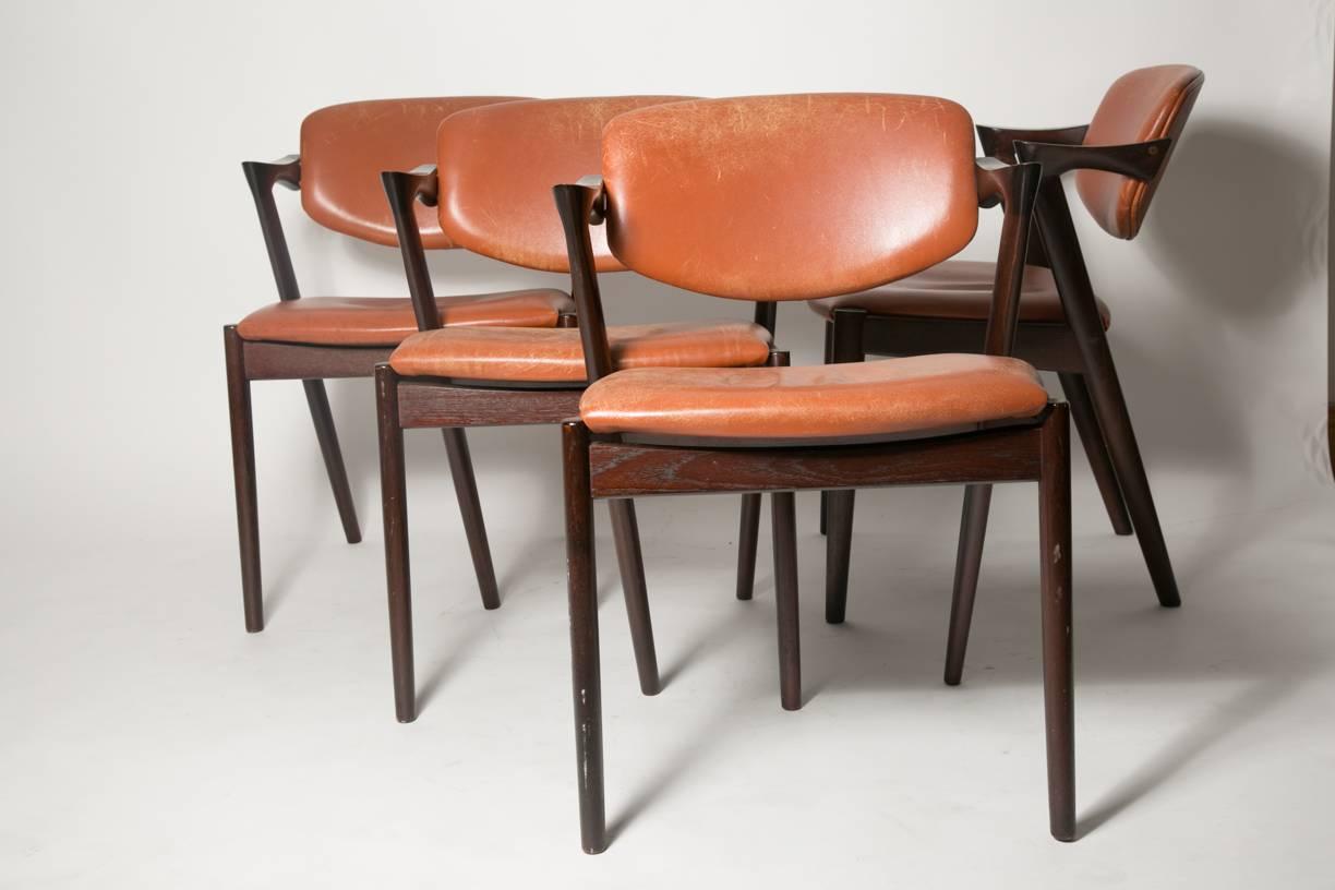 A second set of four dining chair from Danish designer Kai Kristiansen. This version of the ‘Z’ chairs has a back and seat upholstered with a bright cognac leather which is a rare color for such a model. Designed in the late 1950s for V Schou