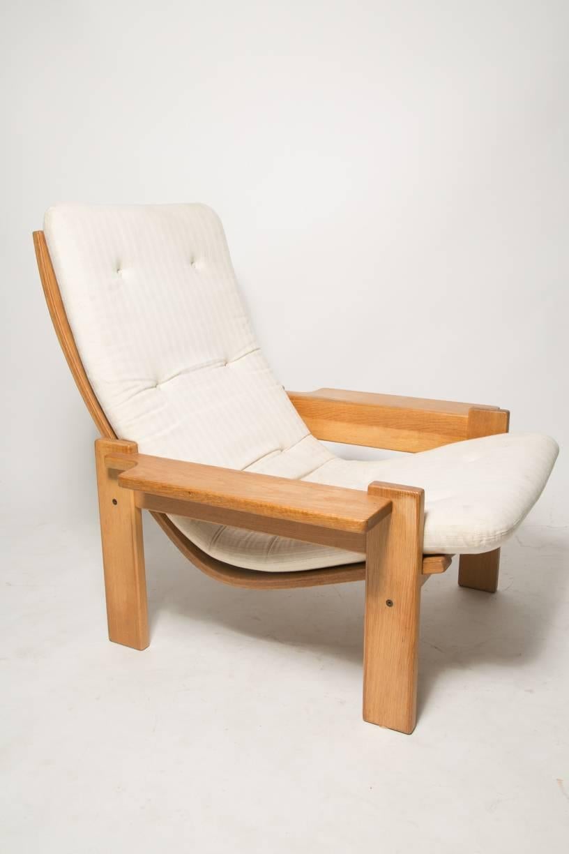 Extremely rare and generously proportioned pair of plank arm lounge chair with curved backrest and stripe textured white fabric from designer Yngve Ekstrom for Swedese. Produced during the late 1960s. Brand's mark underneath the chair. These pair is