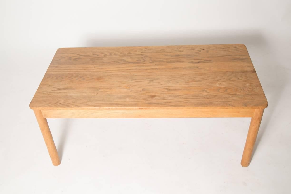 Ultra rare table of solid oak by Børge Mogensen features cylindrical legs and solid wood top. Oak with warm patina and rustic minimal lines. This table echoes the design of the J39 