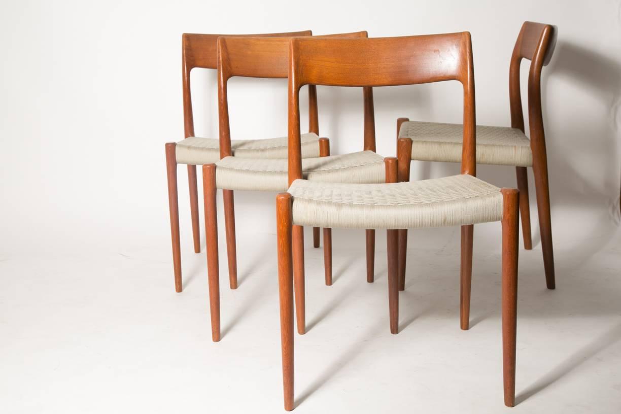 Nice set of four dining chairs model 77 by Niels Otto Møller and manufactured by J.L. Moller in 1950s. The seats are made of flat woven cord of wool string, original and pretty unusual seat option. Seats show light spotting from age and use. Loose