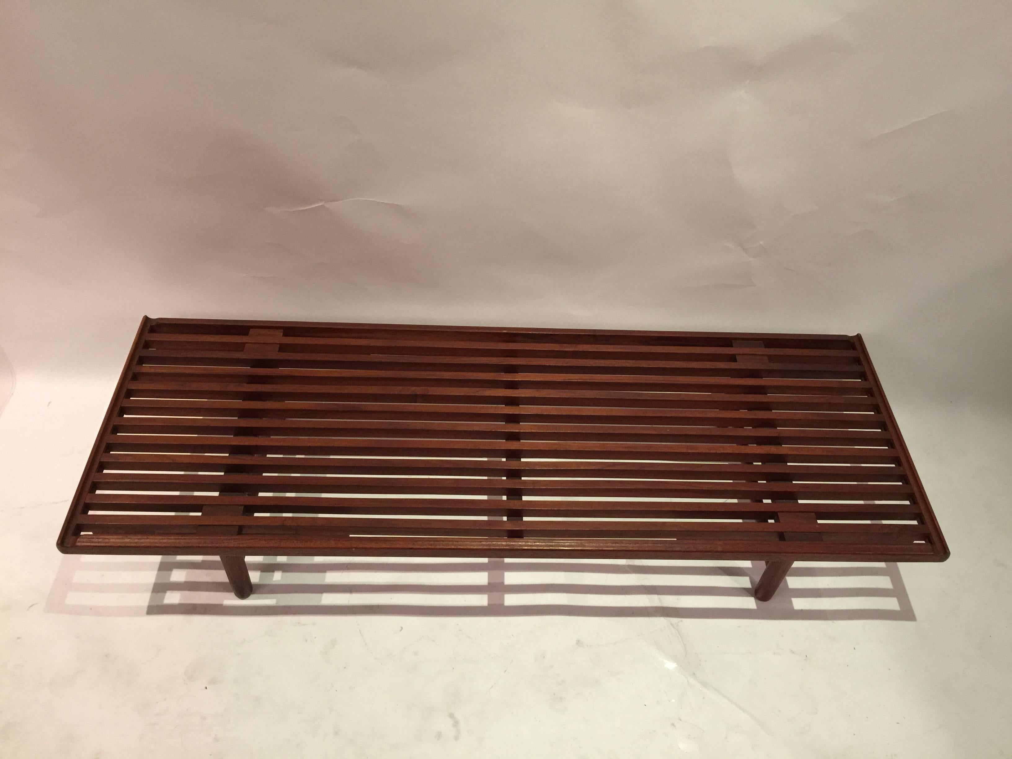 Nicely detailed old growth teak slat bench. Legs reminiscent of the designs of Poul Volther. Also features pleasing bevelled edges and high quality workmanship.