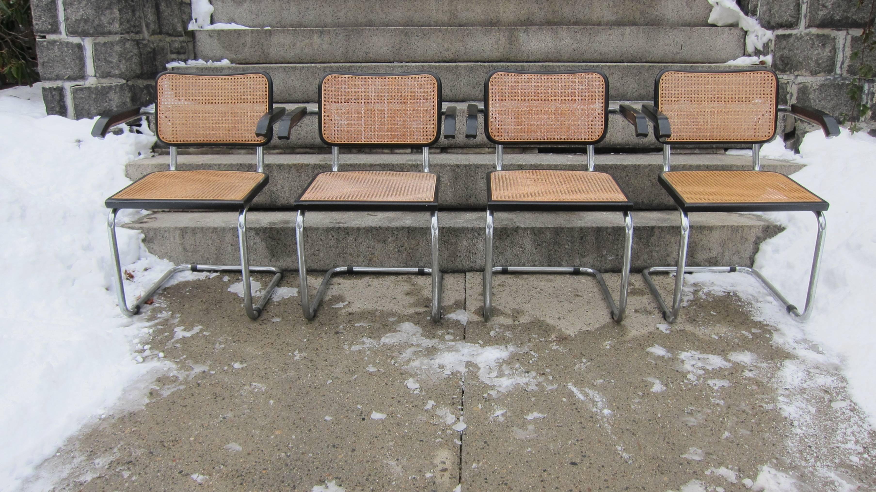 Eight Cesca chairs designed by Marcel Breuer. In good original condition with no broken cane. Made in Italy. These are do not appear to be the Knoll version and show no Knoll markings. They bear labels that say "Made in Italy" and are