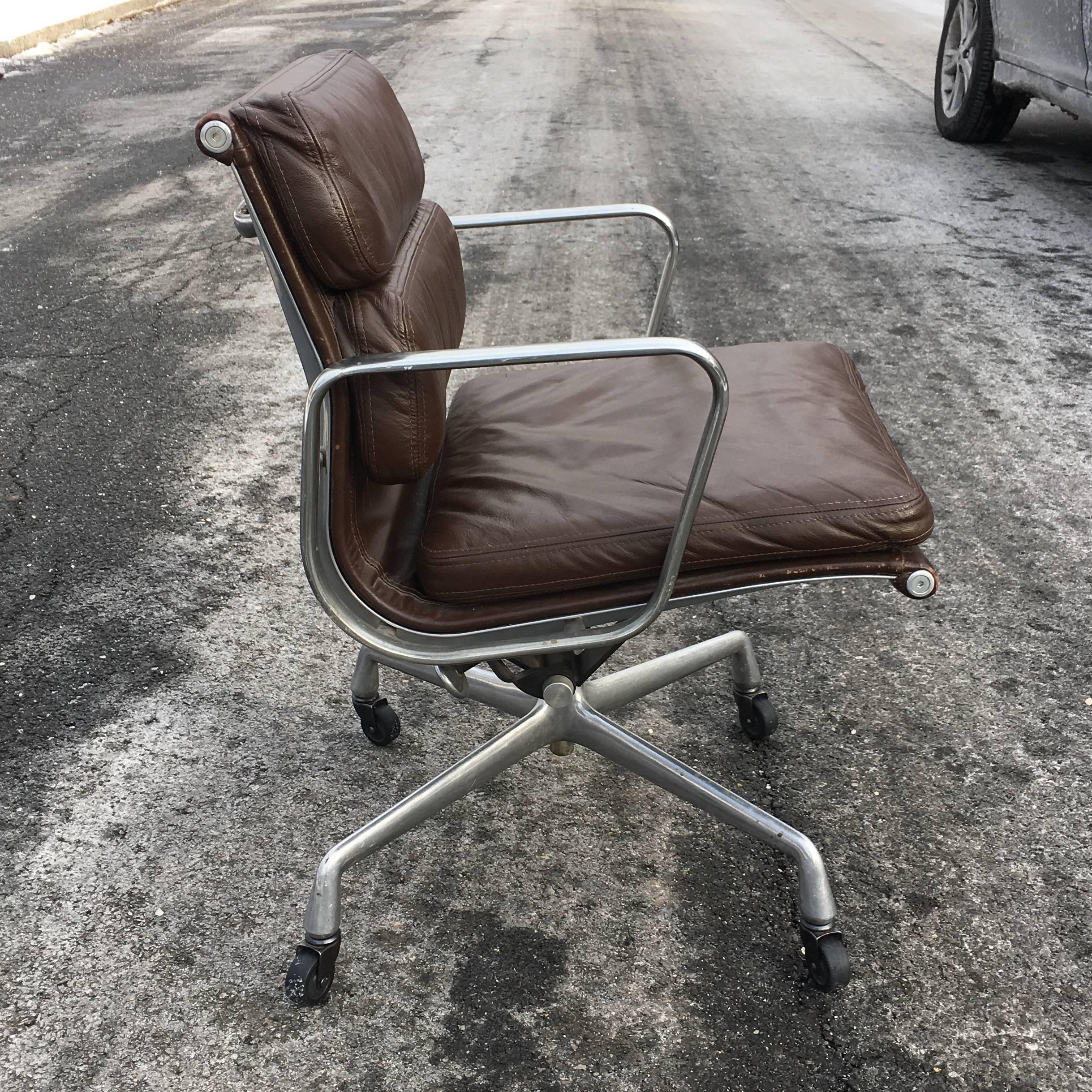 Four original matching Herman Miller Eames soft pad management armchairs. Brown leather in excellent condition. No tears or dryness. Purchased from original owner. Chairs date to 1970s. Signed with black Herman Miller tag. Normal wear including