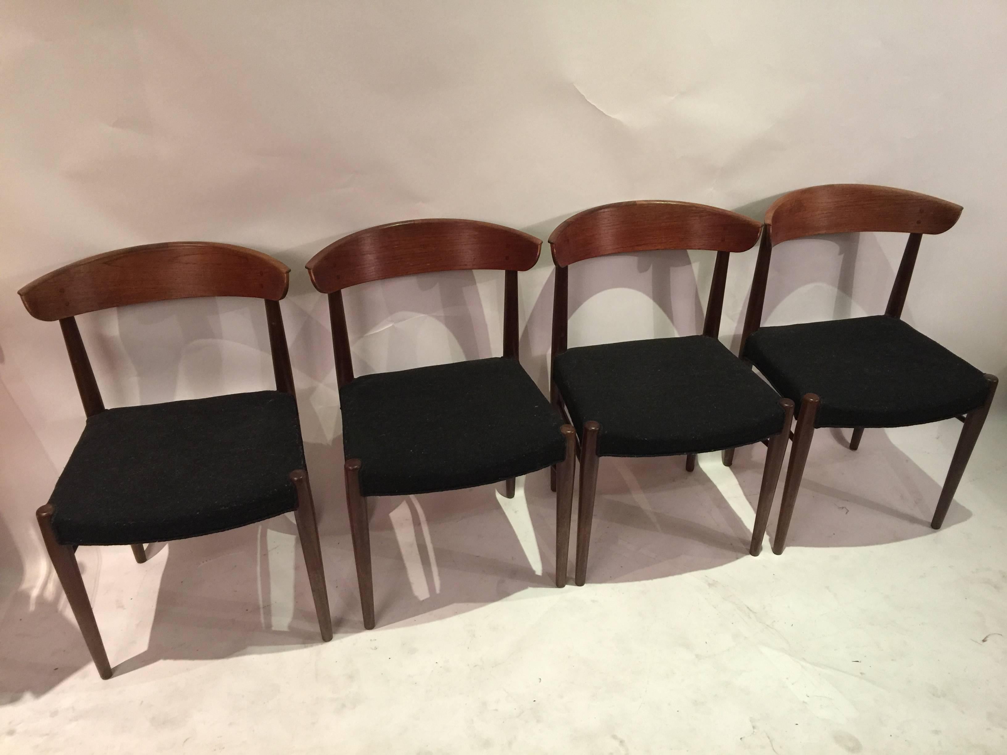 Danish master cabinet maker chairs in textured black fabric. Curved backs are fixed to the frame with peg joints. Scratches and hairline to one chair backrest support. Noticeable wear and tear to edges and corner.
Contact us for refinishing and