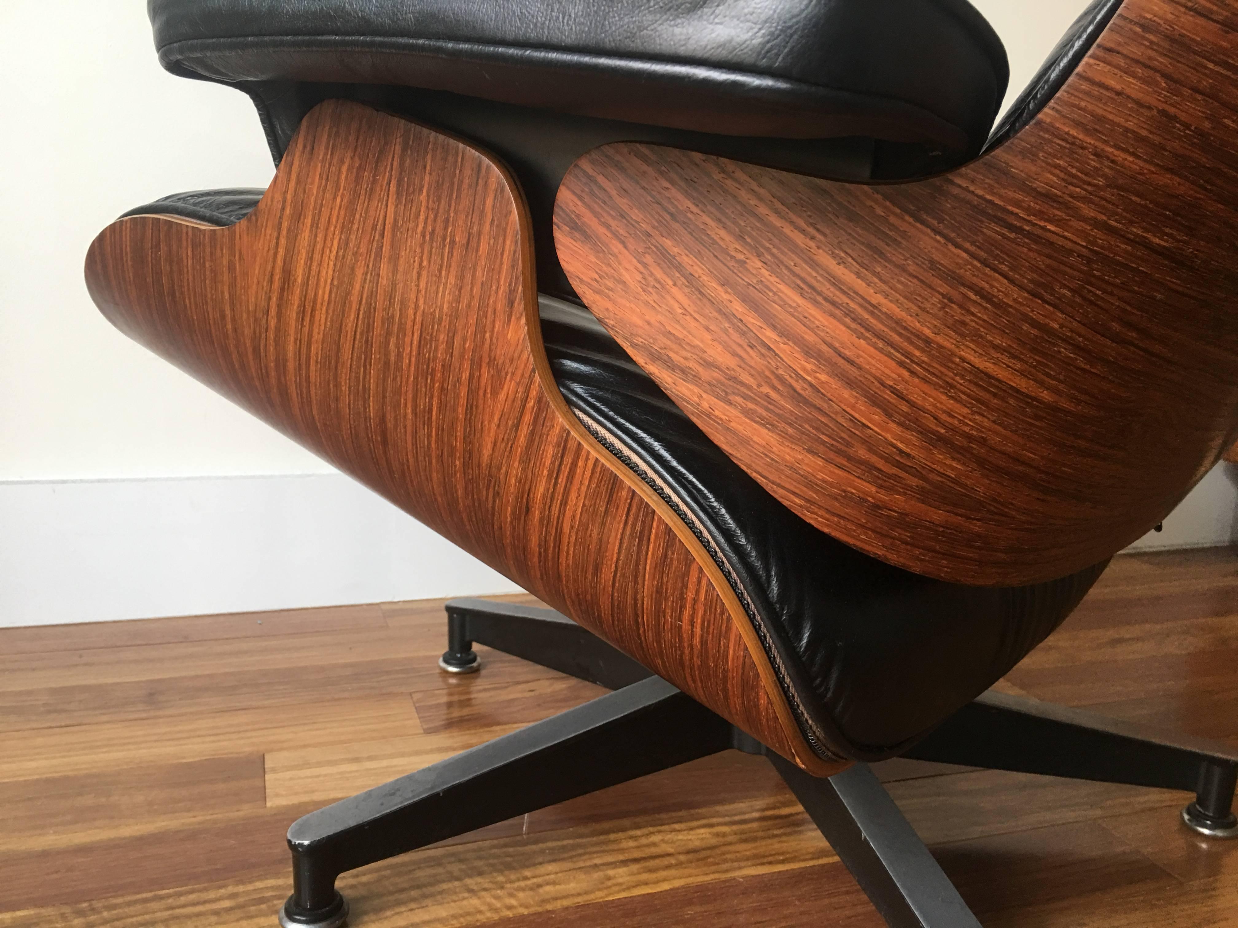 Original Herman Miller Eames rosewood lounge chair and ottoman from 1980s. In original condition with near perfect rosewood. Typical wear to cushions. No rips or holes. Shock mounts have been professionally redone by Hume Modern.