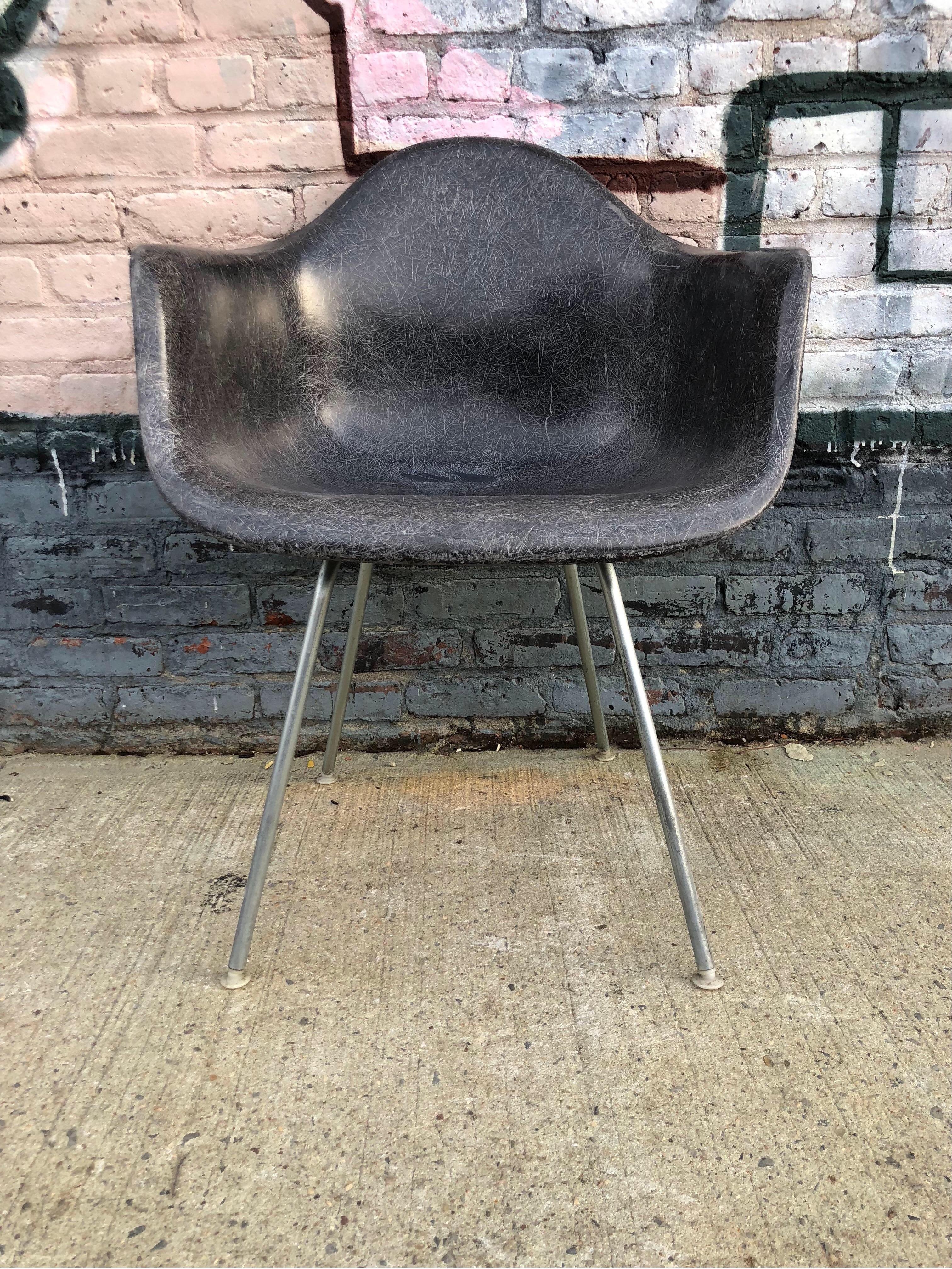 Rare Herman Miller Eames fiberglass armchair. DAX model in rare color black. Authentic Herman Miller base. All mounts and glides intact. Available with different base options. Embossed Herman Miller, circa 1960s.